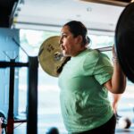 Woman lifting weights in a gym